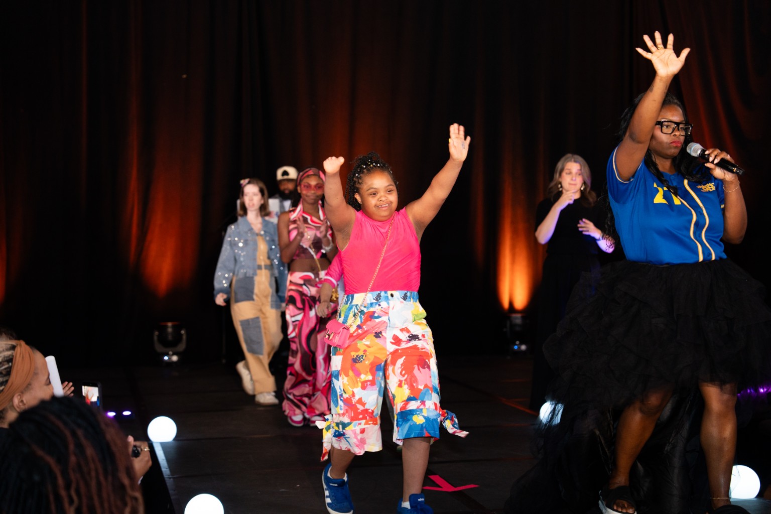 A model walking the Think Out, Be Light runway at Fair Park