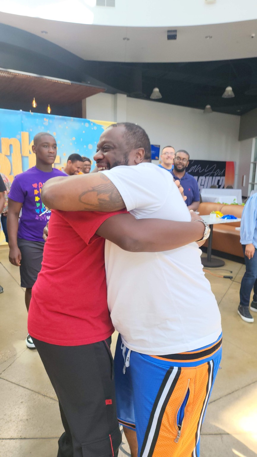 Members of the Third Legacy community sharing a group hug after a Think Out, Be Light event