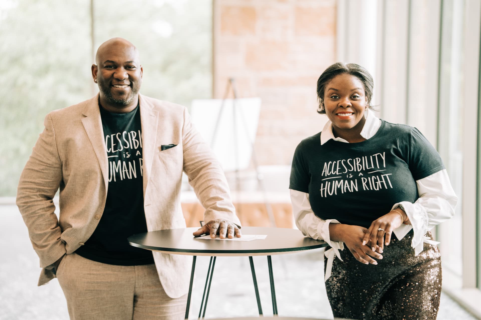 Third Legacy founders Feleceia and Frankie Wilson wearing shirts that read Accessibility is a Human Right